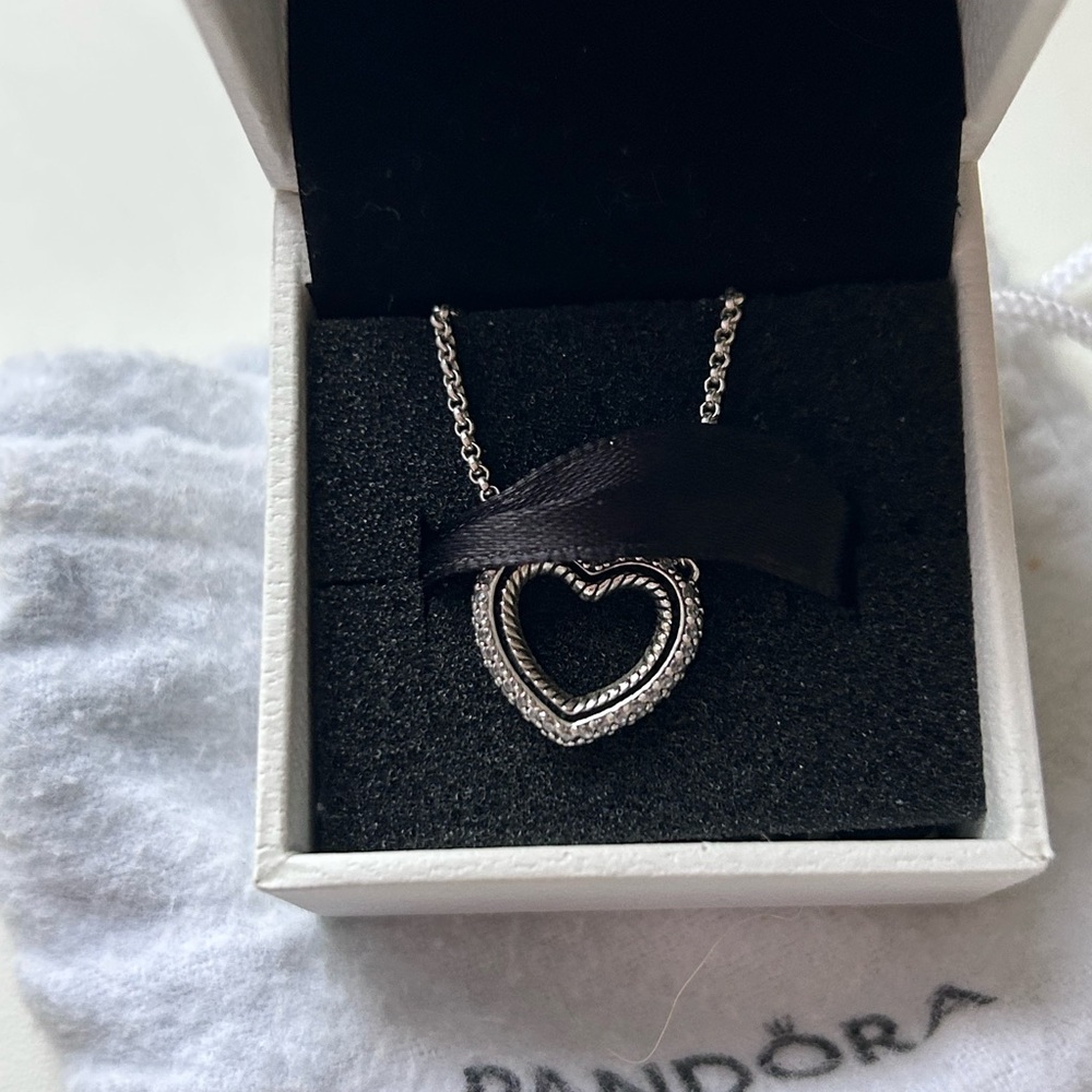Silver pandora heart necklace with box and bag

Sparkling Open Heart Necklace